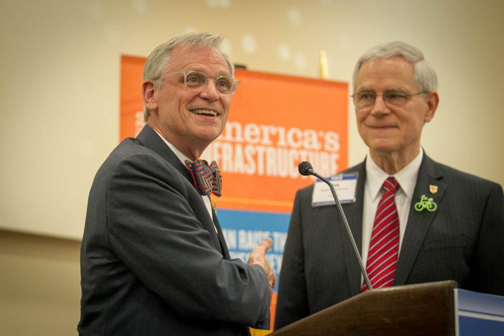 two men at a podium